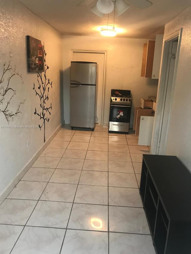 825 E 9th Ln, Hialeah, FL 33010 - kitchen featuring appliances with stainless steel finishes and light tile patterned flooring