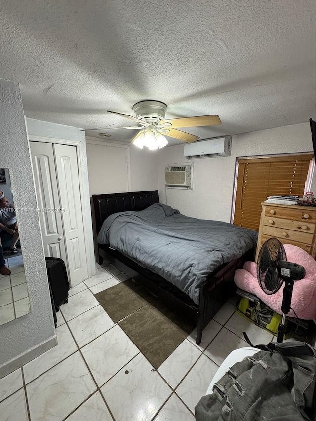825 E 9th Ln, Hialeah, FL 33010 - bedroom with a wall mounted AC, a wall unit AC, a closet, light marble finish flooring, and a textured ceiling