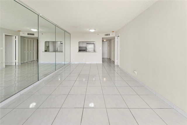 2555 Collins Ave Unit 2104, Miami Beach, FL 33140 - spare room with light tile patterned floors and a textured ceiling