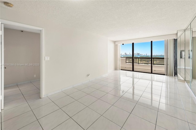 2555 Collins Ave Unit 2104, Miami Beach, FL 33140 - spare room featuring a textured ceiling, light tile patterned floors, and a smoke detector