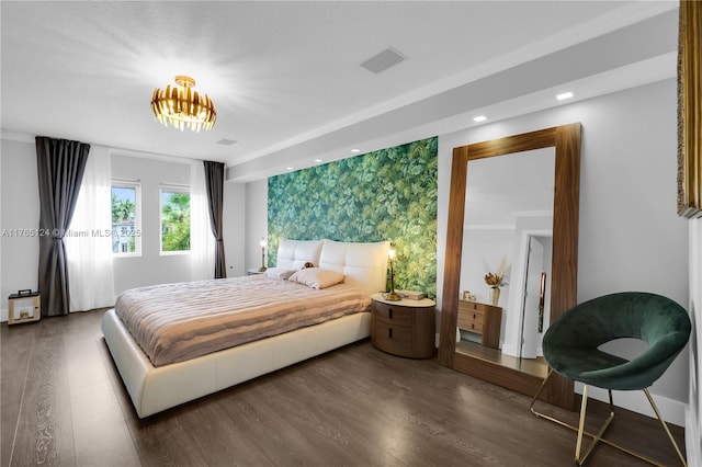 bedroom with recessed lighting, wood finished floors, an accent wall, and wallpapered walls