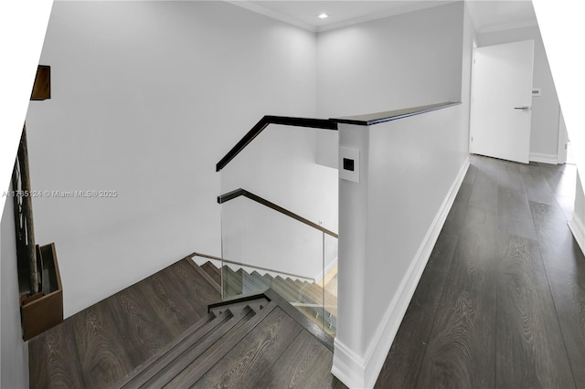 staircase with recessed lighting, ornamental molding, baseboards, and wood finished floors