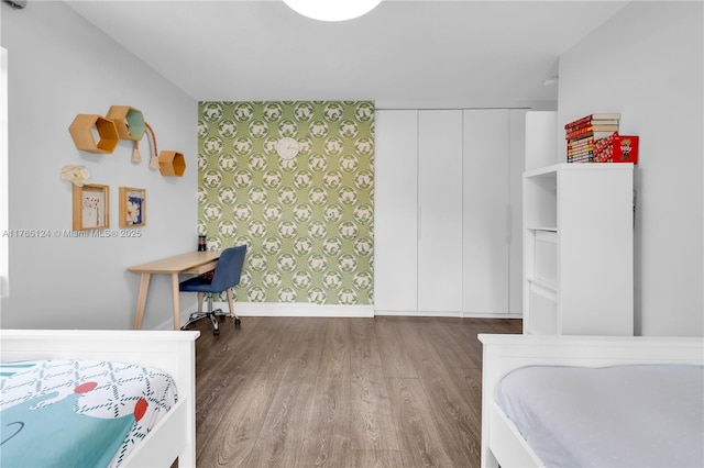 bedroom with wood finished floors and baseboards