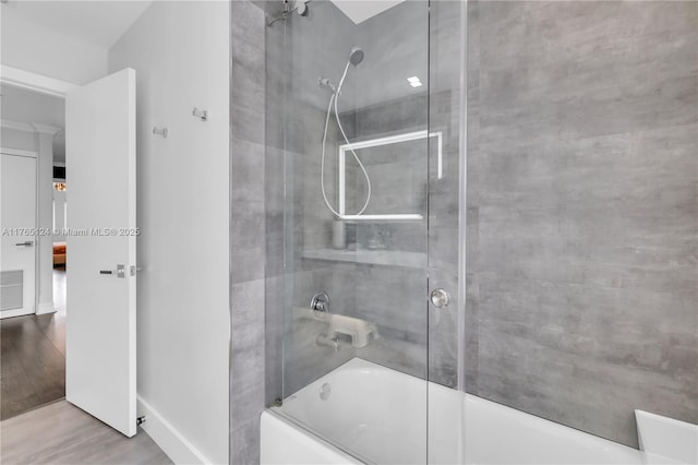 full bath featuring visible vents, wood finished floors, and bath / shower combo with glass door