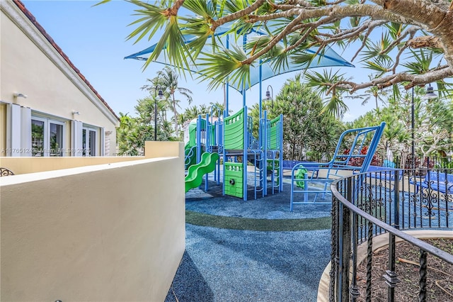 view of patio with fence and playground community