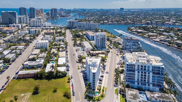 birds eye view of property featuring a view of city and a water view