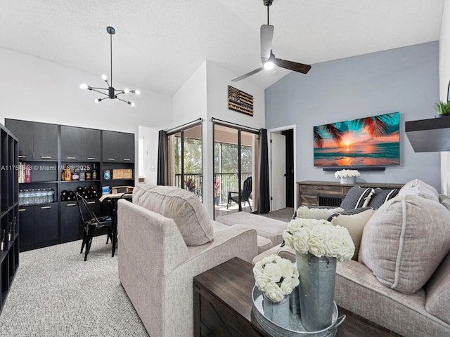 living area with light carpet, high vaulted ceiling, and ceiling fan with notable chandelier