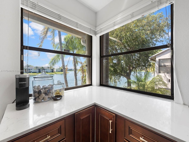 kitchen with a water view and light countertops