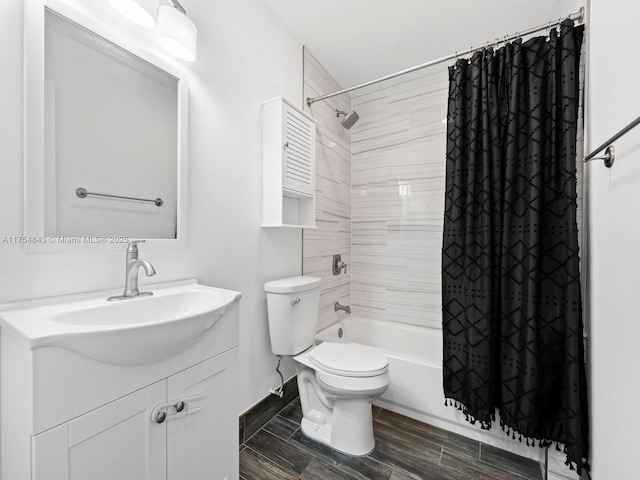 bathroom with wood finish floors, toilet, shower / bath combo, and vanity