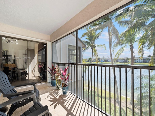 sunroom / solarium with a water view