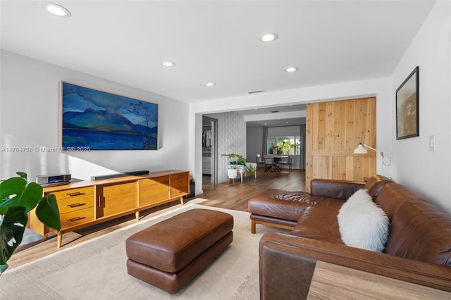living room with light wood finished floors and recessed lighting