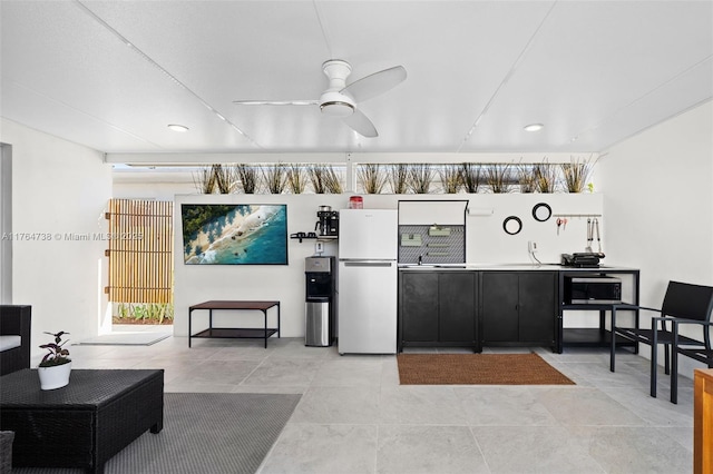 7770 Hawthorne Ave, Miami Beach, FL 33141 - kitchen featuring dark cabinets, a ceiling fan, freestanding refrigerator, healthy amount of natural light, and recessed lighting