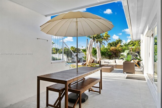 7770 Hawthorne Ave, Miami Beach, FL 33141 - view of patio featuring an outdoor living space, stairs, and outdoor dining space