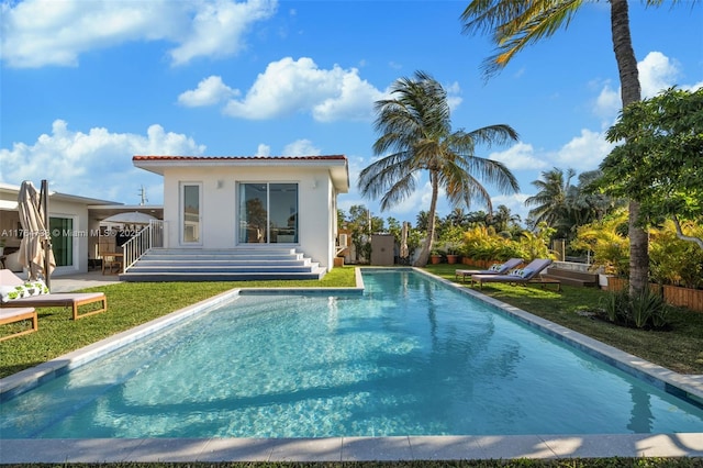 outdoor pool with an outbuilding and a patio