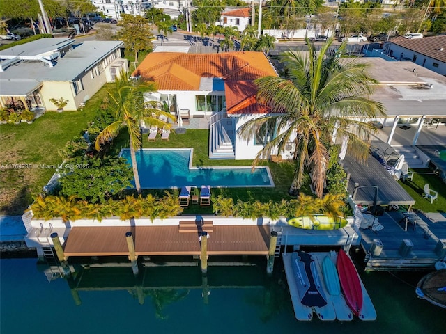 drone / aerial view of a pool and a nearby body of water