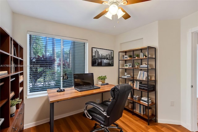 home office featuring baseboards, a ceiling fan, and wood finished floors