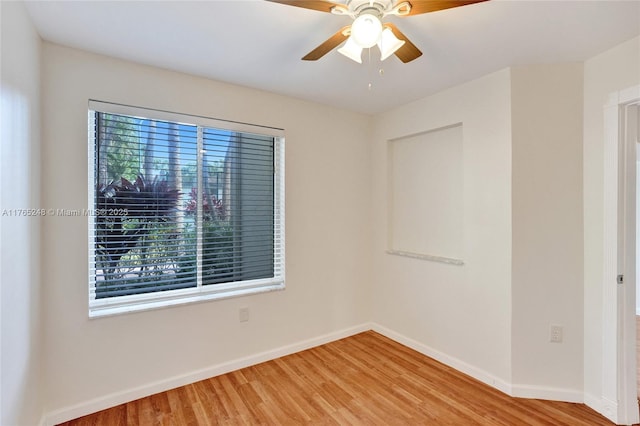 unfurnished room featuring ceiling fan, baseboards, and light wood-style floors