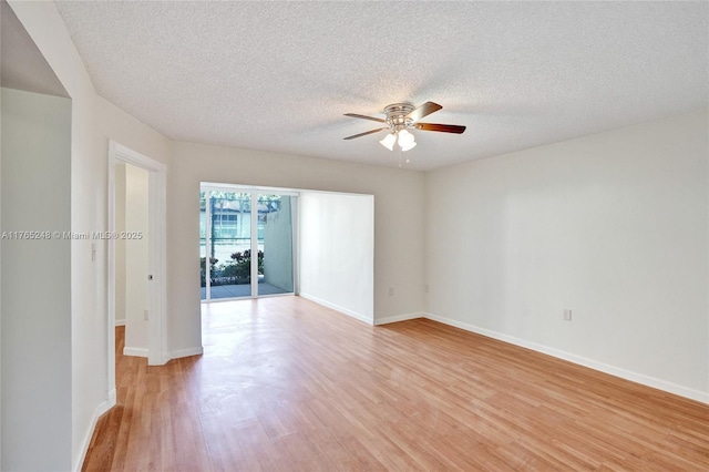 empty room featuring baseboards, light wood finished floors, and ceiling fan