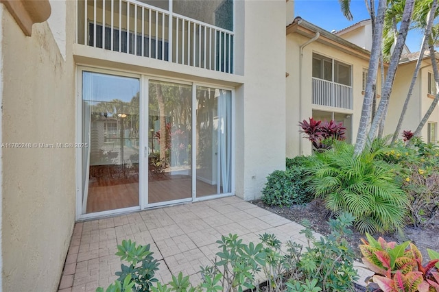 doorway to property with stucco siding