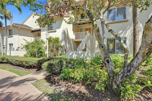 exterior space with stucco siding and stairs