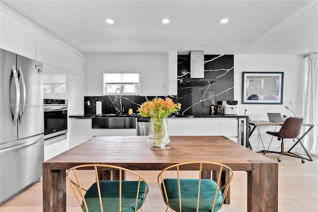 4000 NE 170th St Unit 300, North Miami Beach, FL 33160 - kitchen featuring decorative backsplash, white cabinetry, stainless steel appliances, and a sink