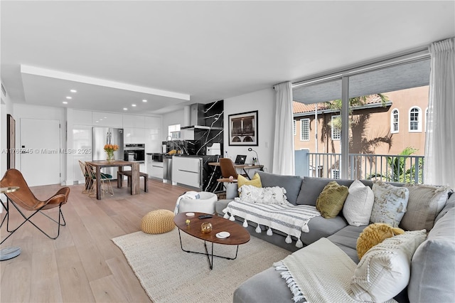 4000 NE 170th St Unit 300, North Miami Beach, FL 33160 - living room with recessed lighting, light wood-style floors, and a healthy amount of sunlight