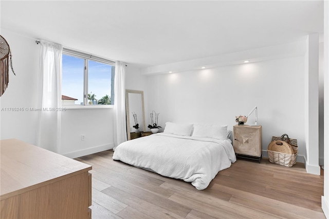 4000 NE 170th St Unit 300, North Miami Beach, FL 33160 - bedroom with light wood finished floors and baseboards