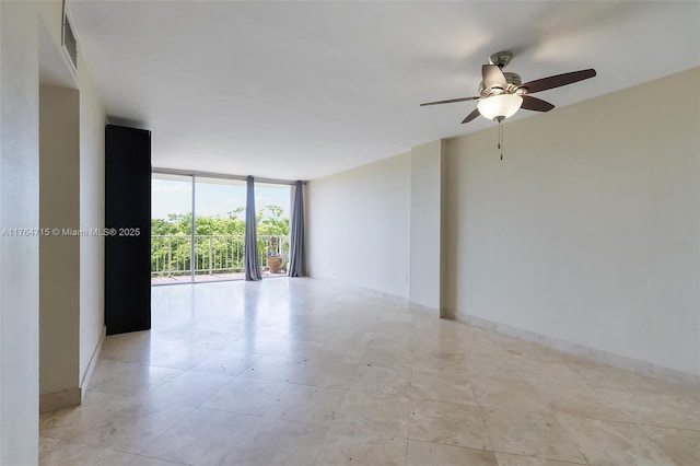 unfurnished room with floor to ceiling windows, light tile patterned floors, visible vents, and ceiling fan