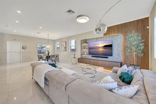 living area featuring recessed lighting, visible vents, wood walls, and baseboards