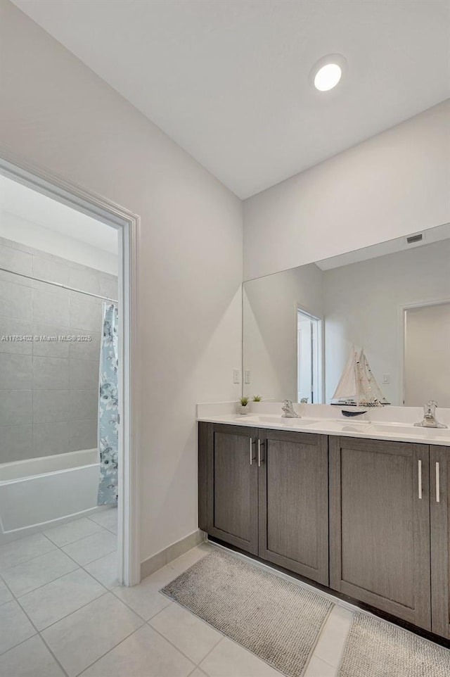 full bath with tile patterned flooring, baseboards, double vanity, shower / bath combination with curtain, and a sink