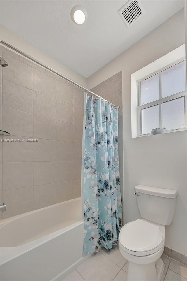 full bath with tile patterned flooring, visible vents, toilet, and shower / tub combo