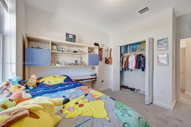 bedroom with visible vents, baseboards, a closet, and carpet flooring