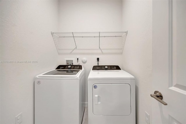 laundry area featuring washing machine and dryer and laundry area
