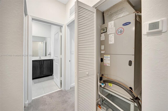 utilities featuring heating unit and a sink