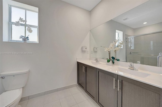 full bathroom featuring tile patterned flooring, a shower stall, baseboards, toilet, and a sink