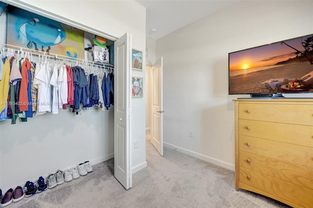 bedroom with baseboards, a closet, and carpet floors