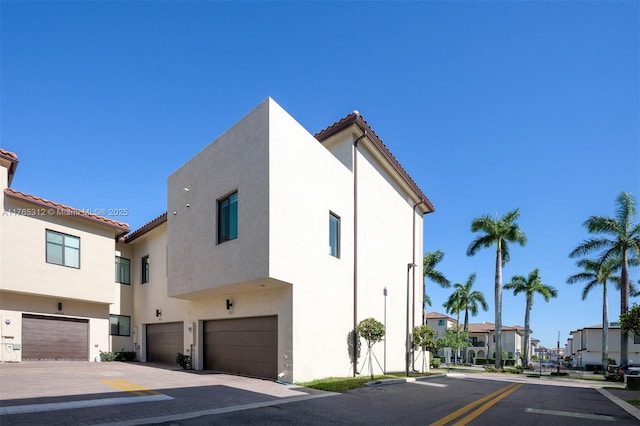 8321 Central Park Blvd, Doral, FL 33166 - exterior space with stucco siding, a residential view, an attached garage, and a tiled roof
