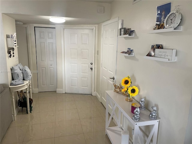 interior space featuring tile patterned floors and baseboards