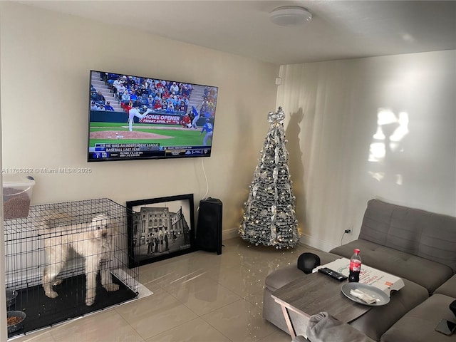 living area with tile patterned floors and baseboards