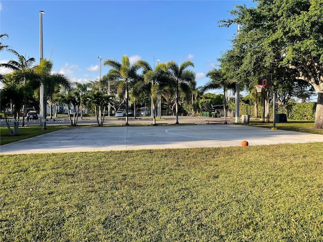 view of home's community with community basketball court and a yard