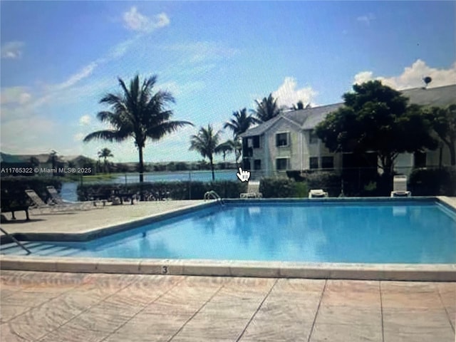 pool featuring a patio area and fence
