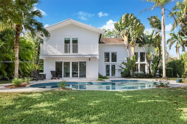 13575 SW 72nd Ave, Pinecrest, FL 33156 - back of house featuring a balcony, french doors, an outdoor pool, a yard, and a patio area