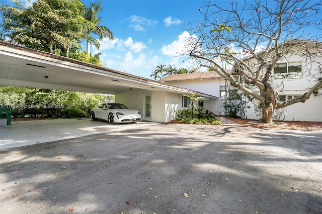 13575 SW 72nd Ave, Pinecrest, FL 33156 - view of side of property with driveway and a carport