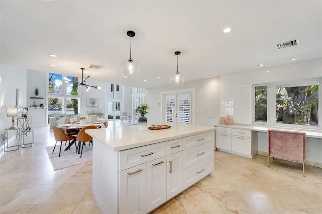 13575 SW 72nd Ave, Pinecrest, FL 33156 - kitchen featuring plenty of natural light, white cabinetry, pendant lighting, a kitchen island, and recessed lighting