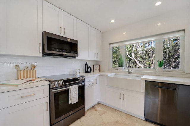 13575 SW 72nd Ave, Pinecrest, FL 33156 - kitchen featuring appliances with stainless steel finishes, backsplash, light countertops, white cabinetry, and light tile patterned floors