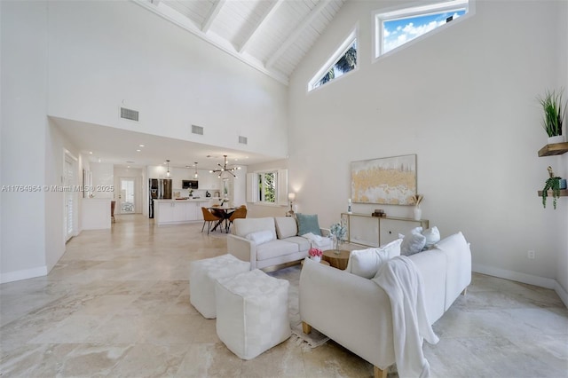 13575 SW 72nd Ave, Pinecrest, FL 33156 - living area featuring high vaulted ceiling, plenty of natural light, a chandelier, light marble finish floors, and a wood ceiling with exposed beams