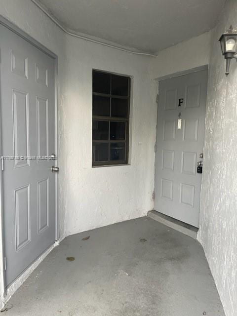 property entrance featuring stucco siding