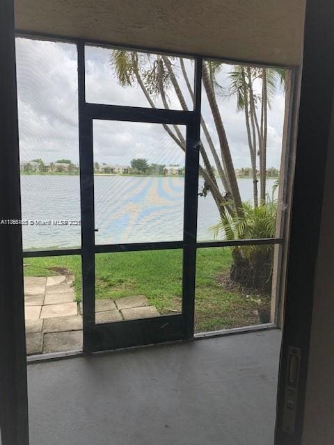 interior space with concrete flooring and a water view