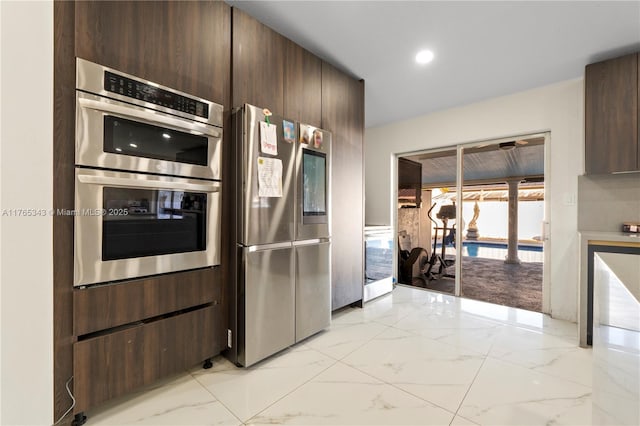 kitchen with marble finish floor, dark brown cabinetry, and stainless steel appliances