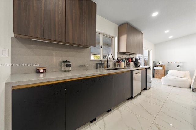 kitchen featuring modern cabinets, stainless steel dishwasher, light countertops, marble finish floor, and recessed lighting